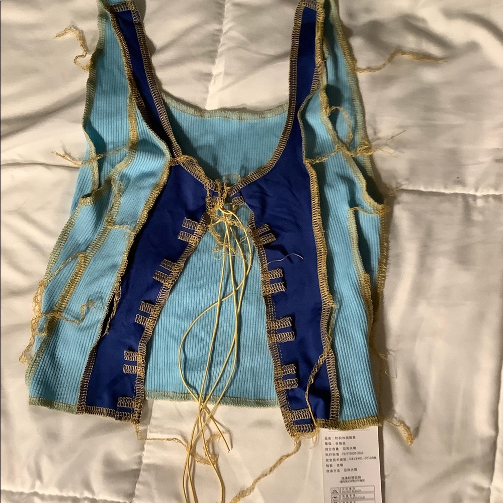 Nice, New and very cute and colorful lace up top size small.